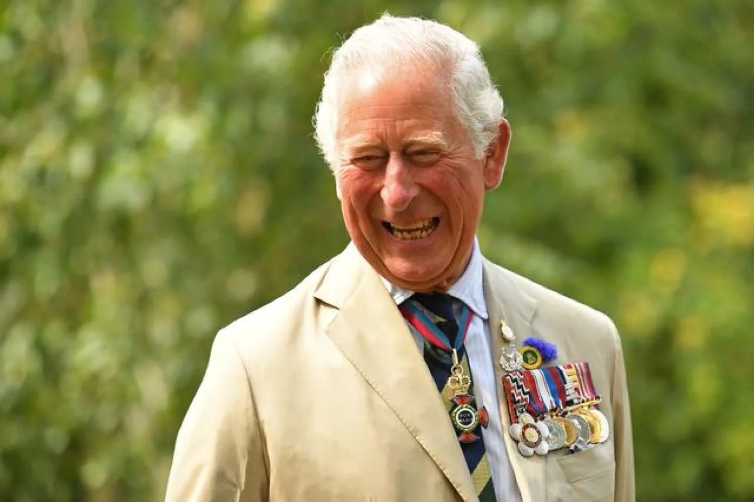FILE PHOTO: Britain's Prince Charles smiles as he speaks with relatives of veterans, during the VJ Day National Remembrance event held at the National Memorial Arboretum in Staffordshire, Britain August 15, 2020. Oli Scarff/Pool via REUTERS