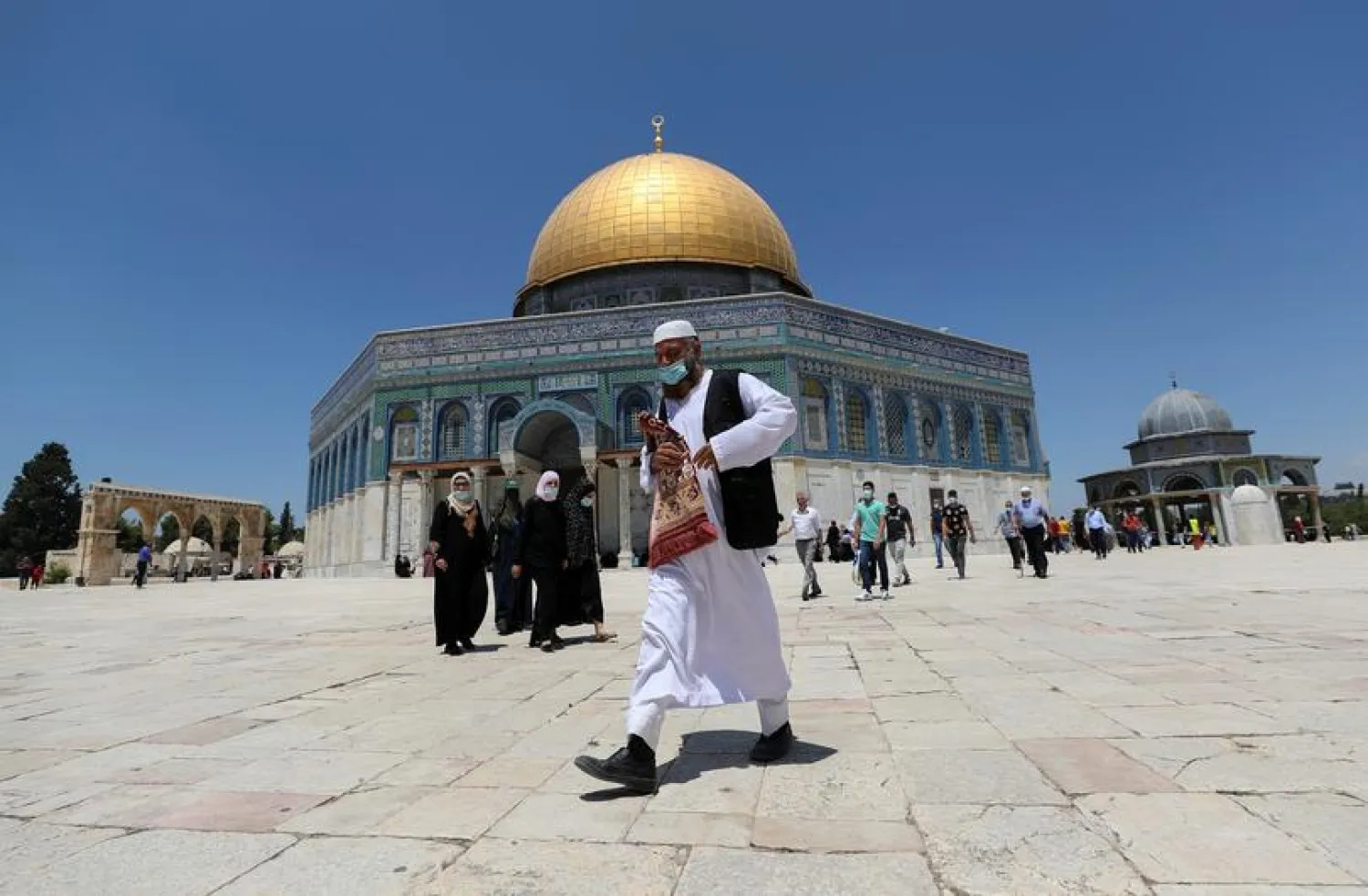 A Muslim man walks in front of the Dome of the Rock on the compound known to Muslims as Noble Sanctuary and to Jews as Temple Mount, in Jerusalem's Old City, August 14, 2020. REUTERS/Ammar Awad