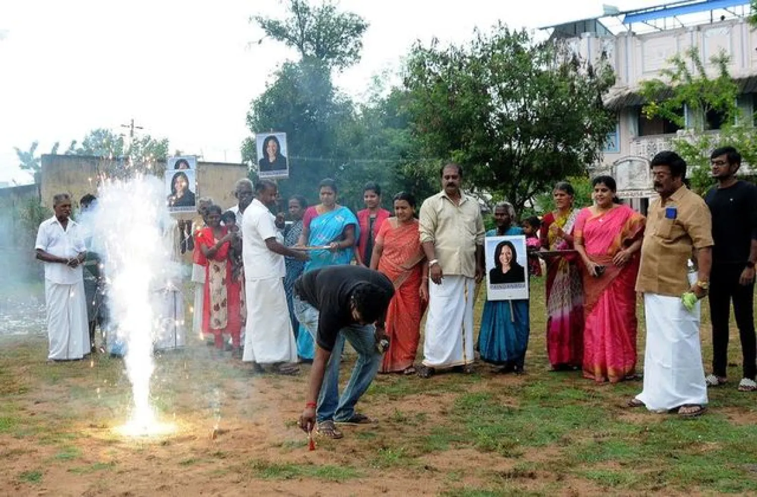 A man lights fireworks as villagers gather to celebrate the victory of US Vice President-elect Kamala Harris in Painganadu near the village of Thulasendrapuram, where Harris' maternal grandfather was born and grew up, in the southern state of Tamil Nadu, India, November 8, 2020. REUTERS/StringerREUTERS