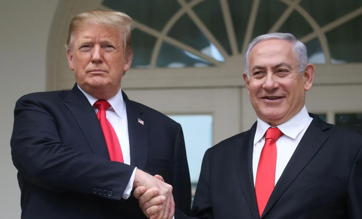 US President Donald Trump shakes hands with Israel's PM Benjamin Netanyahu as they pose at the White House in Washington, US, March 25, 2019. (Reuters)