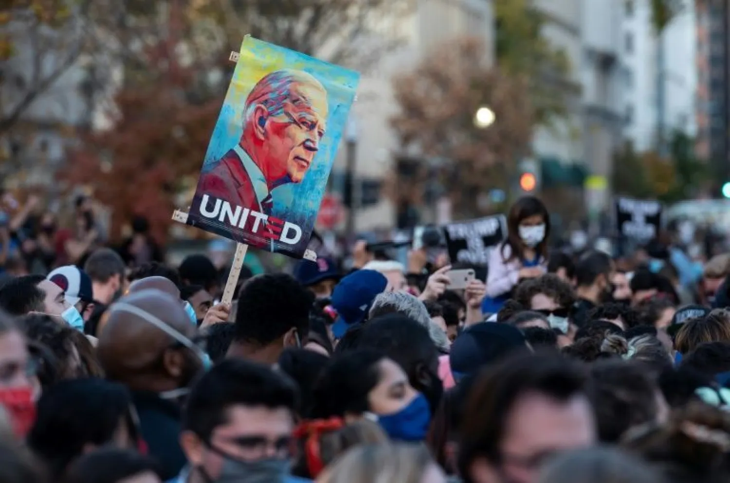 People celebrate Joe Biden's victory in the election at Black Lives Matter Plaza across from the White House in Washington, DC at the weekend | AFP