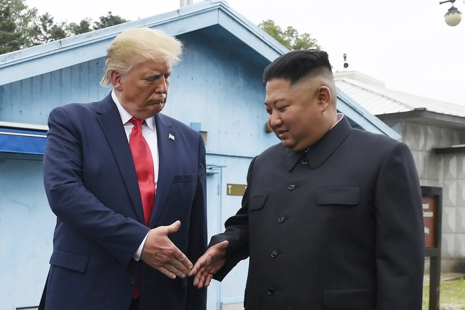 North Korean leader Kim Jong Un (right) and US President Donald Trump prepare to shake hands at the border village of Panmunjom in the Demilitarized Zone, South Korea, June 30, 2019. (AP)