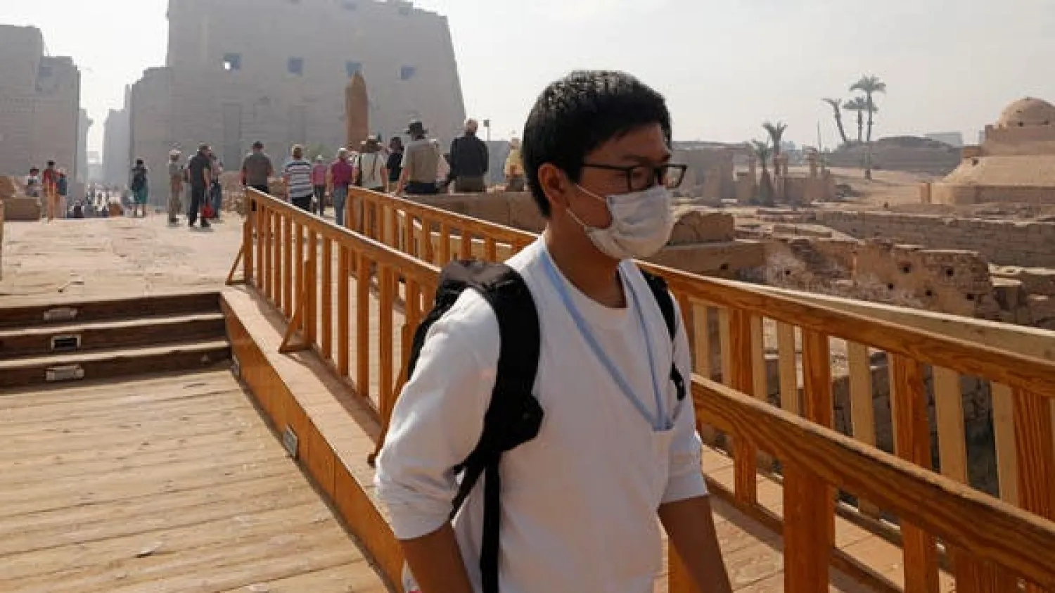A tourist wears a protective mask, following an outbreak of the coronavirus, during his visit to Luxor Temple in Egypt, March 9, 2020. (Reuters)
