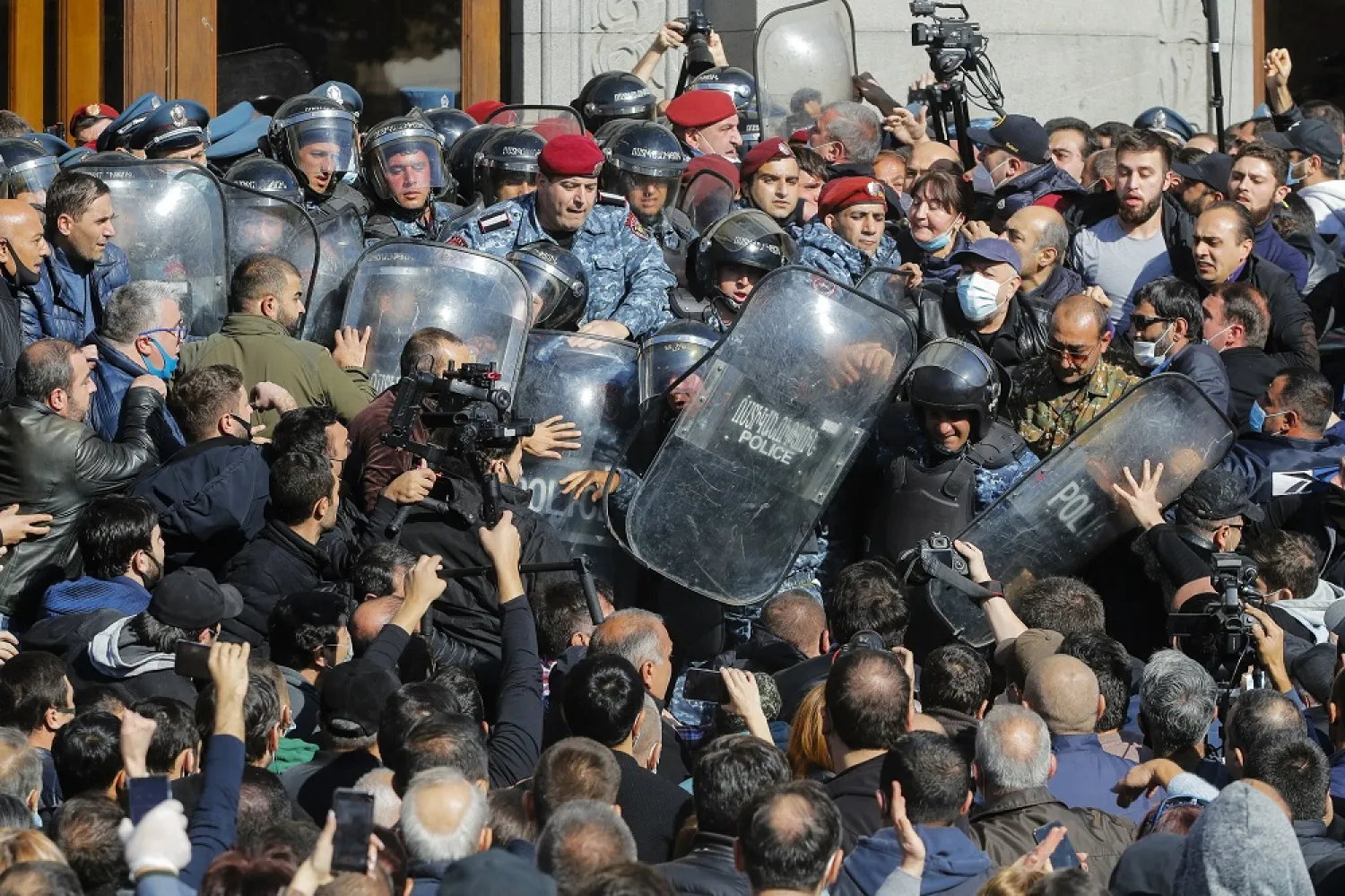 People argue with police during a protest against an agreement to halt fighting over the Nagorno-Karabakh region, in Freedom Square in Yerevan, Armenia, Wednesday, Nov. 11, 2020. (AP)