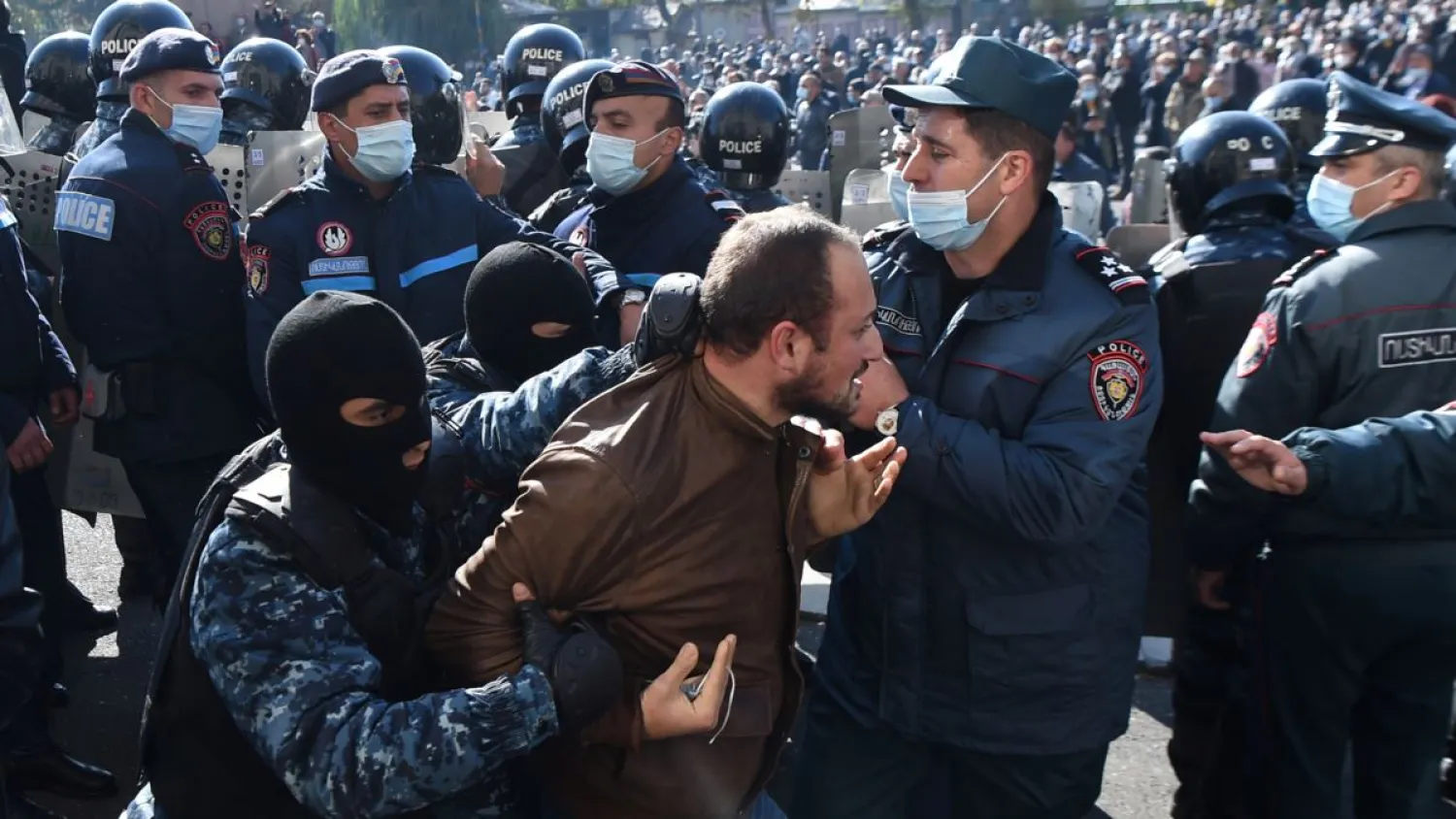 A man is taken away by law enforcement officers during an opposition rally to demand the resignation of Armenian Prime Minister Nikol Pashinian. Reuters