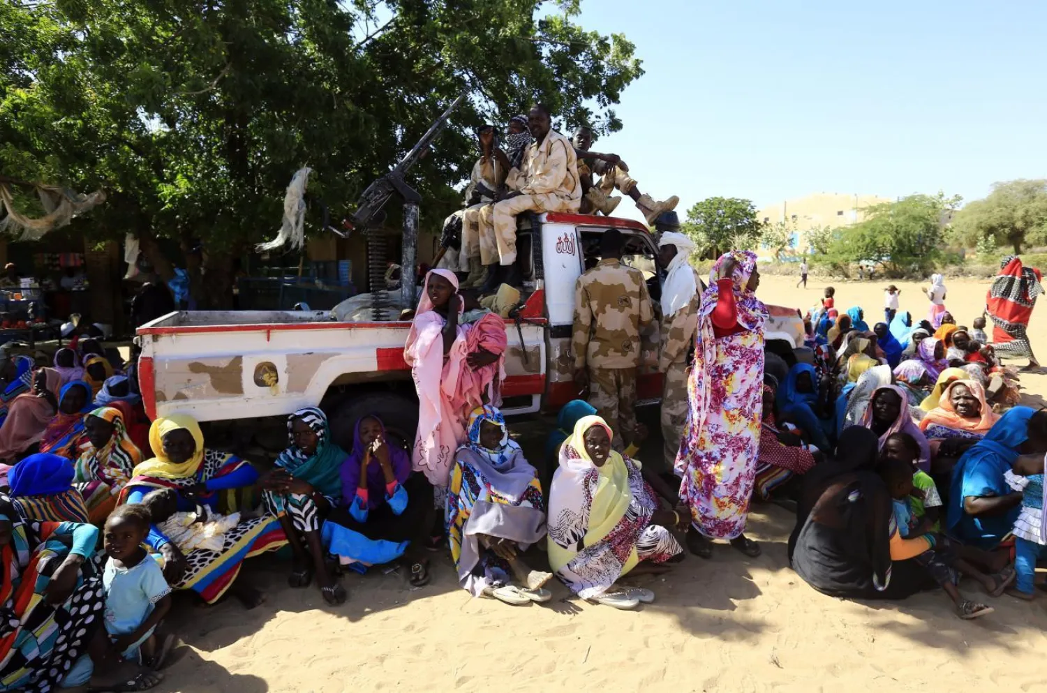 Women sit near a vehicle of the special police forces in North Darfur. Reuters file photo