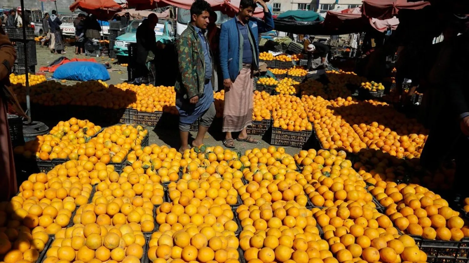Yemenis shop for oranges at a wholesale market in Sanaa. (EPA)