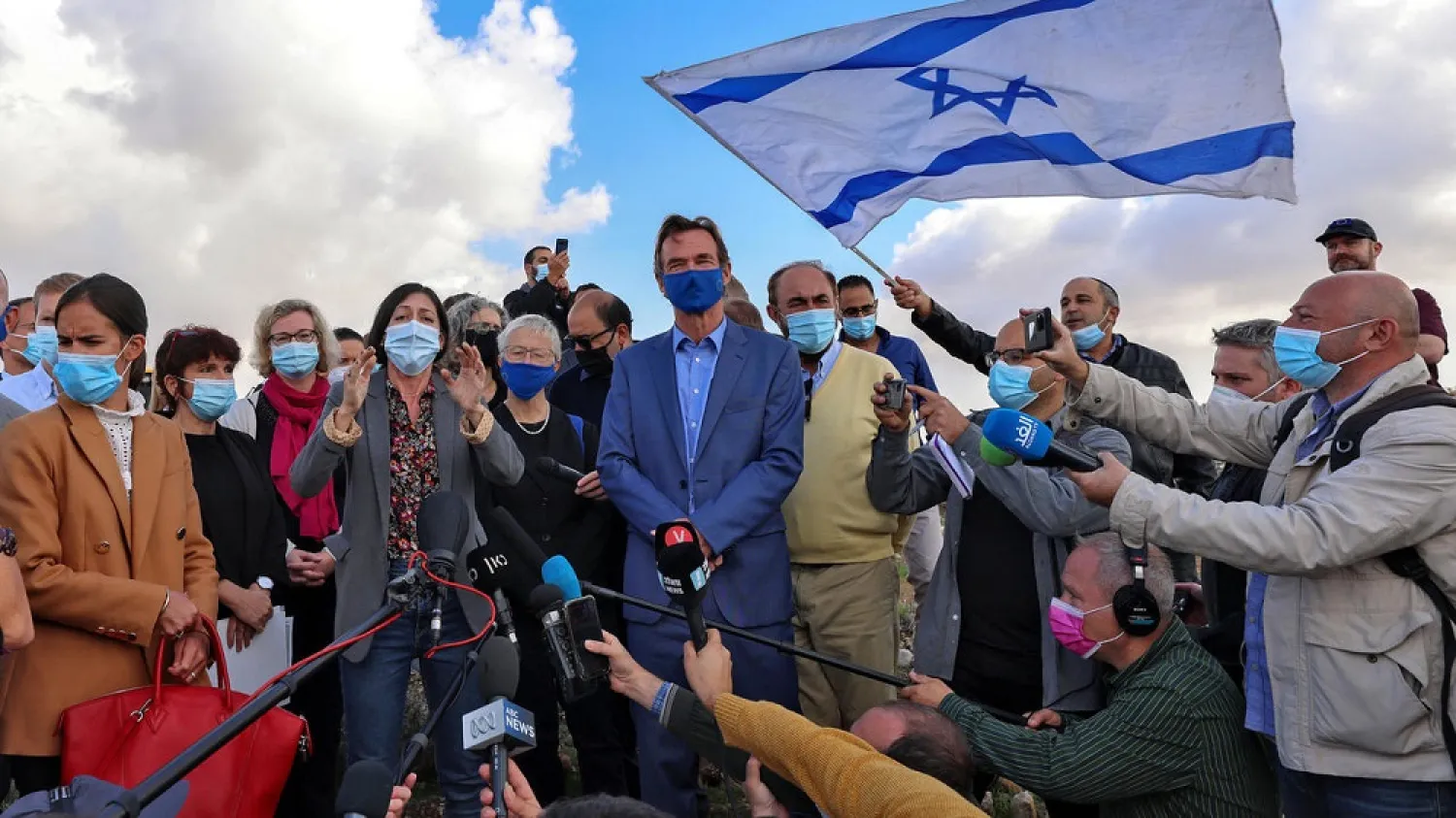 EU representative in the Palestinian territories Sven Kuhn von Burgsdorff (C) is heckled by Israeli protesters as at the site of a planned settler neighborhood in east Jerusalem. (AFP)