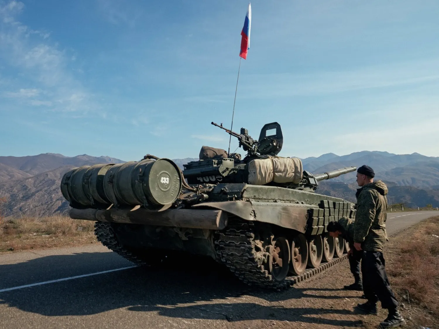 Service members of the Russian peacekeeping troops stand next to a tank near the border with Armenia in the region of Nagorno-Karabakh, November 10, 2020. (Reuters)