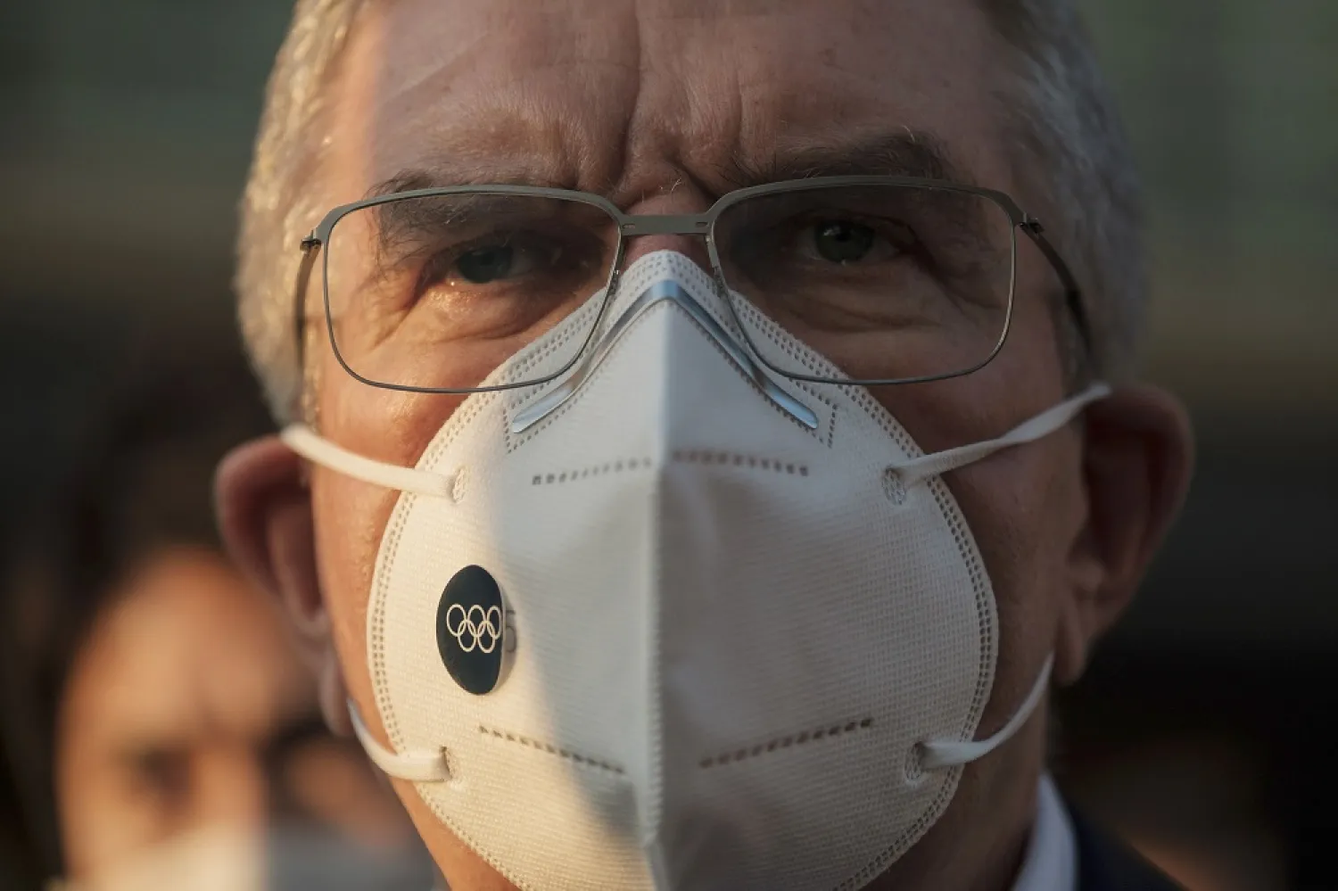IOC President Thomas Bach wearing a protective mask talks to journalists during a visit to Olympic and Paralympic Village in Tokyo, Nov. 17, 2020. (AP)