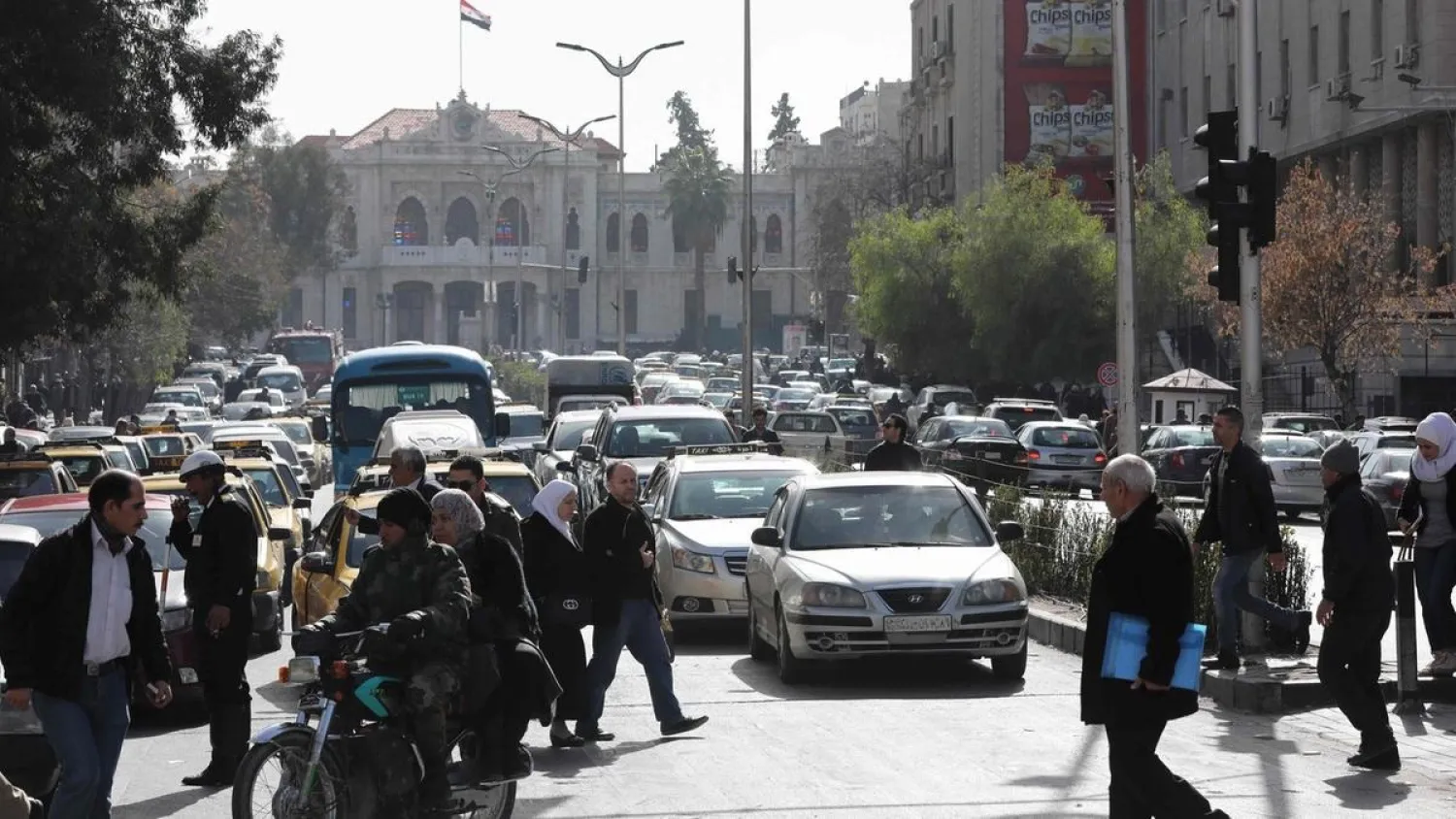 Syrians walk past the traffic in the streets of Hijaz in Damascus. (AFP file photo)