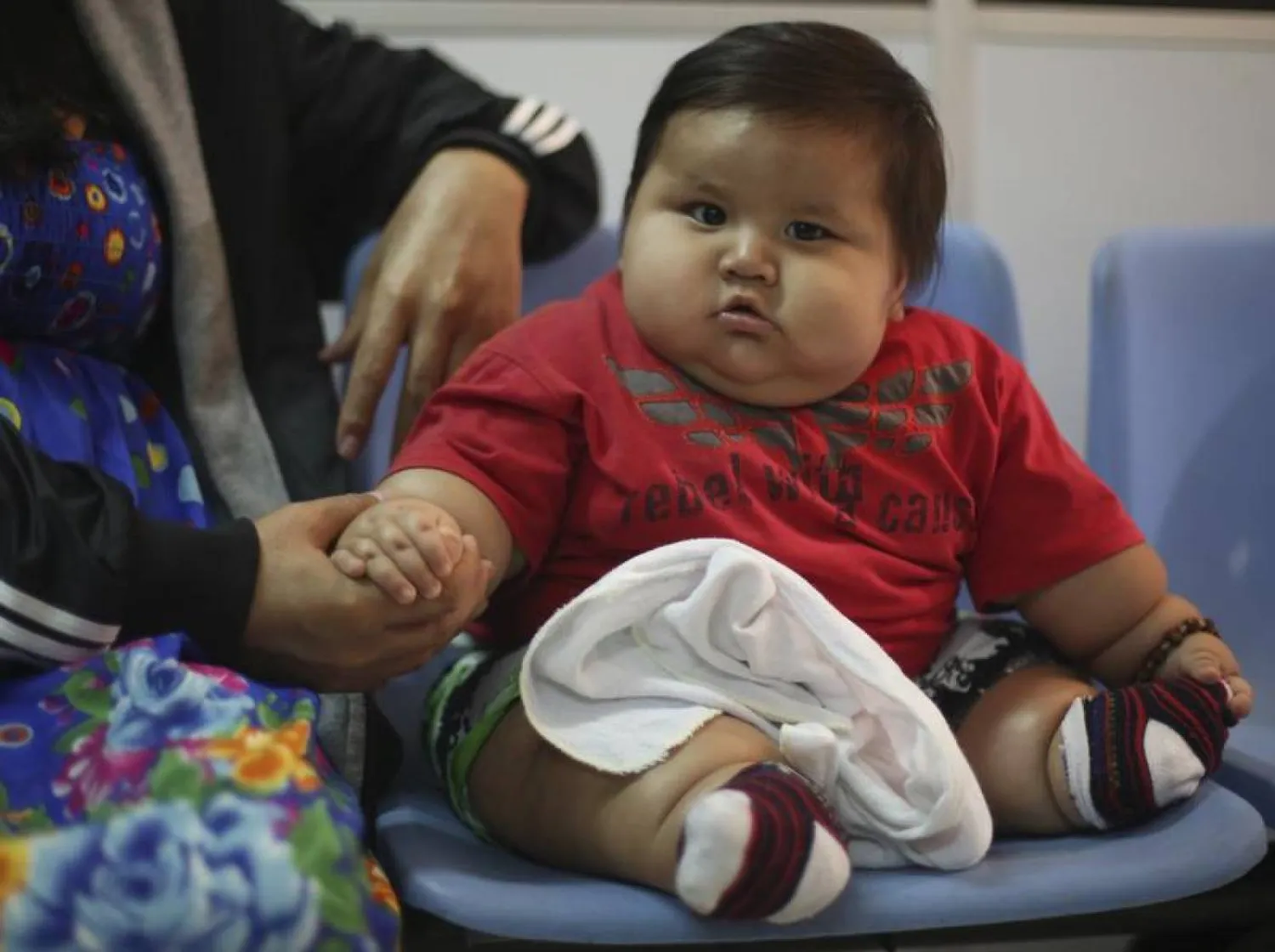Eight-month-old Santiago Mendoza sits at a clinic for the obese in Bogota, Colombia, in this March 19, 2014, archive photo. REUTERS/John Vizcaino