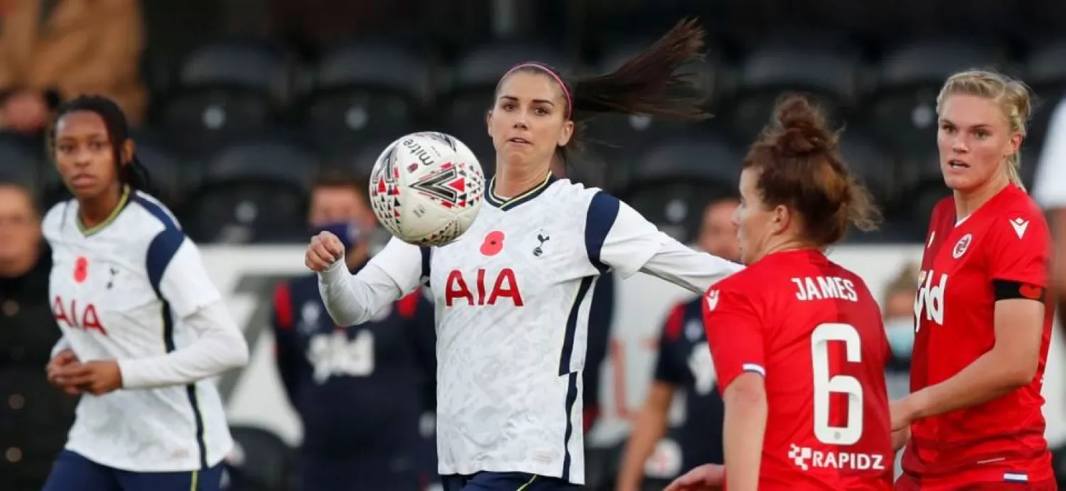 Tottenham Hotspur's Alex Morgan, center, vies for the ball with Reading's Angharad James during the English Women's Super League soccer match between Tottenham Hotspur and Reading at the Hive stadium in London Saturday, Nov. 7, 2020. Morgan came on as a 69th minute substitute, the game ended in a 1-1 draw. (AP Photo/Alastair Grant)