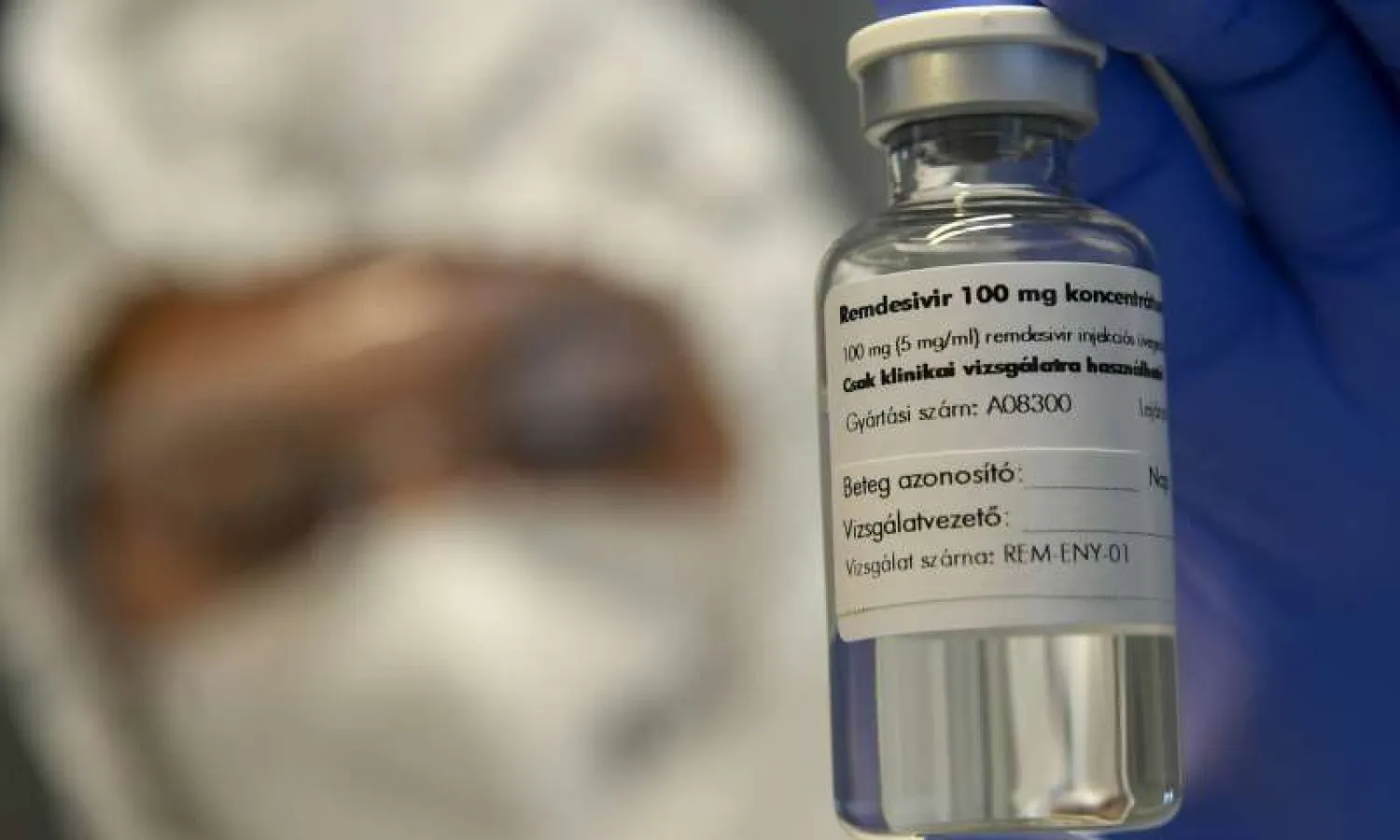 In this Thursday Oct. 15, 2020 file photo, a bottle containing the drug Remdesivir is held by a health worker at the Institute of Infectology of Kenezy Gyula Teaching Hospital of the University of Debrecen in Debrecen, Hungary. (Zsolt Czegledi/MTI via AP, File)