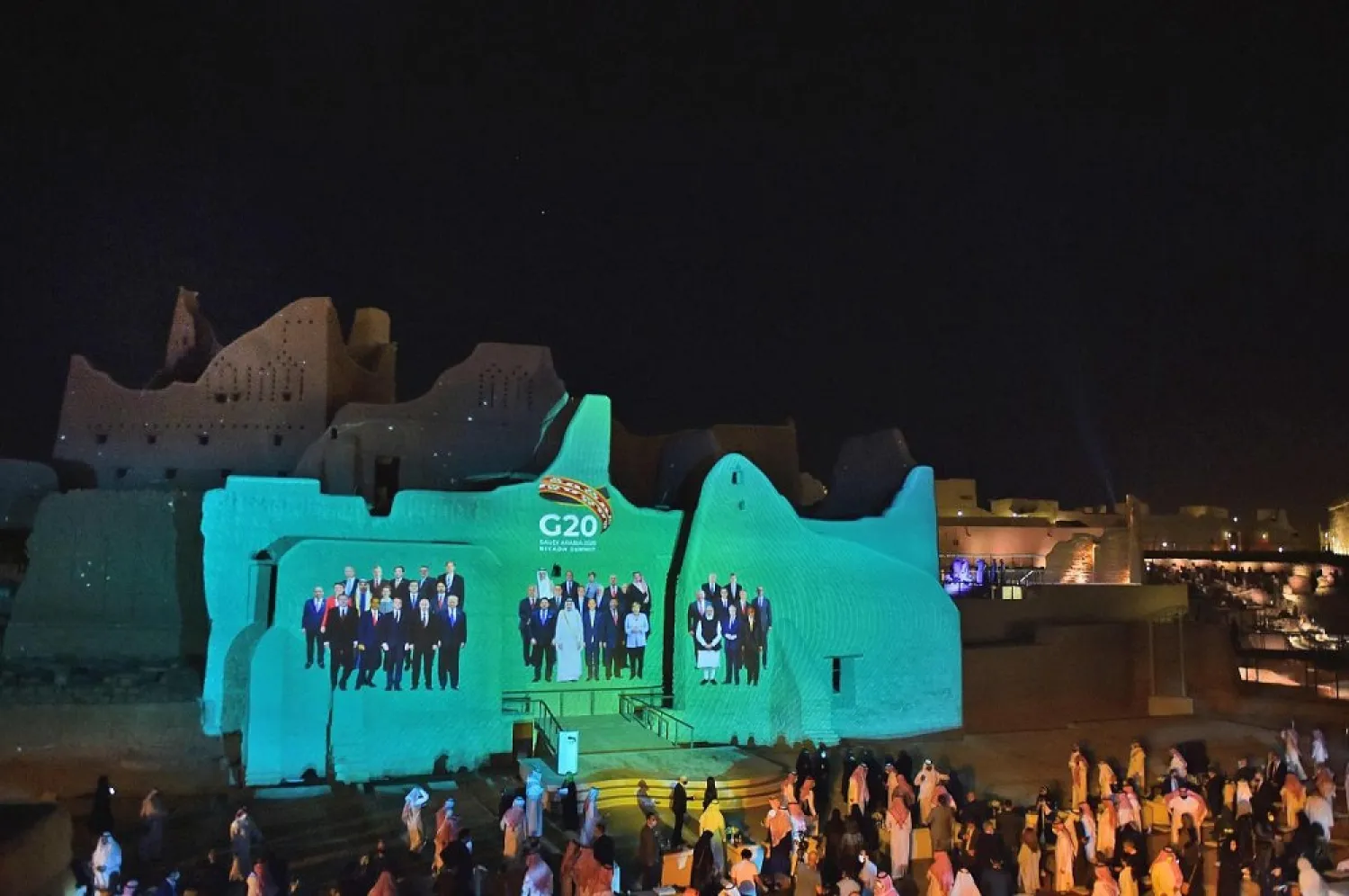 A group photo of global leaders is projected on the walls of landmarks in Saudi Arabia's Diriyah. (AFP)
