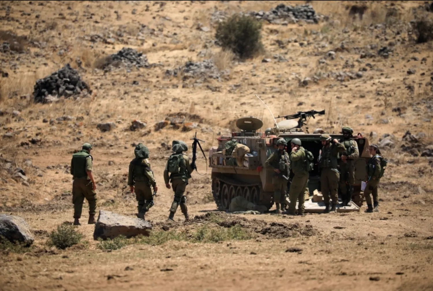 Israeli soldiers walk during a drill in the Israeli-controlled Golan Heights near the Israel-Syria frontier in August [Amir Cohen/Reuters]

 