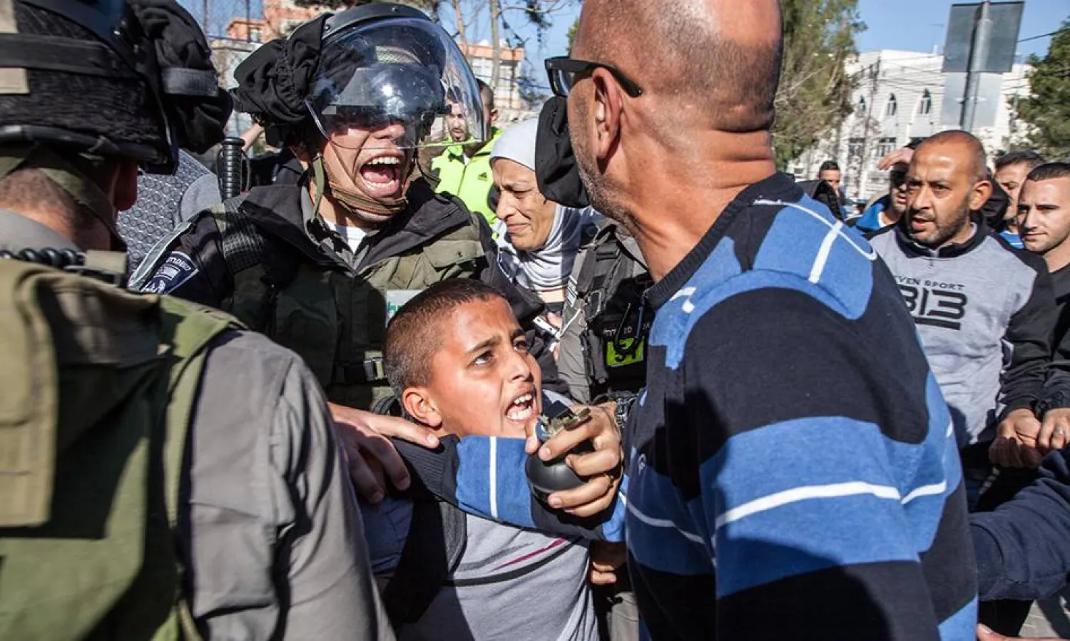 Israeli border police arresting Ahmad Abu Sbitan, 11, in front of his school in East Jerusalem. The police accused him of throwing a stone at them. | Photo: Human Rights Watch/ Majd Gaith