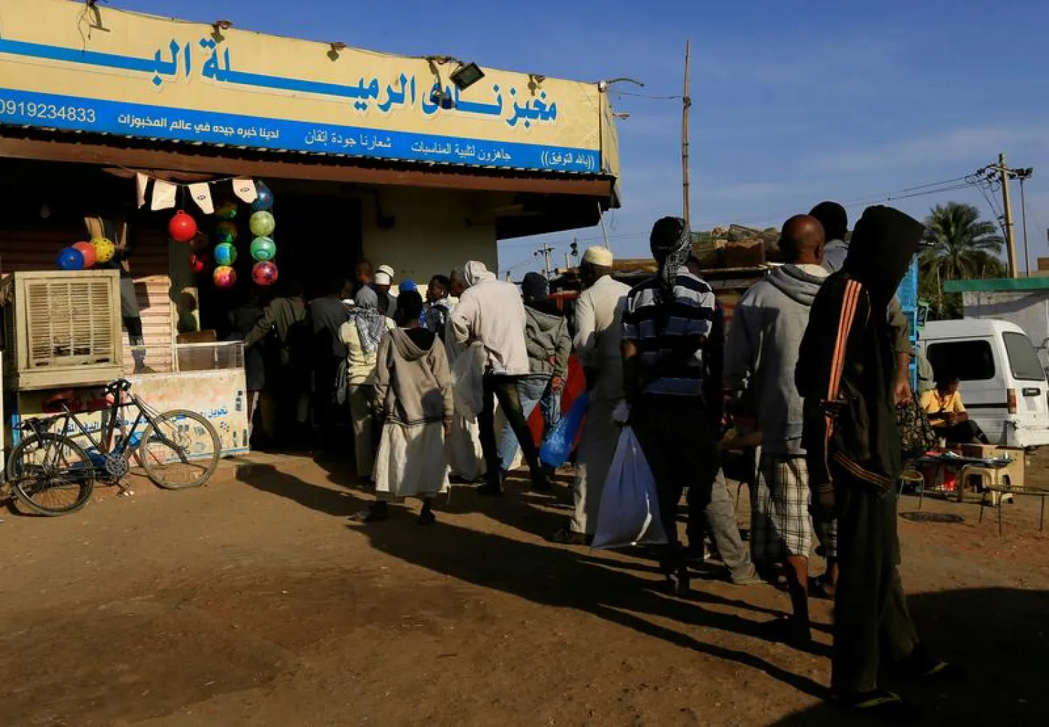 FILE PHOTO: Customers queue to buy bread at a bakery in Khartoum, Sudan February 19, 2020. Picture taken February 19, 2020. REUTERS/Mohamed Nureldin Abdallah
