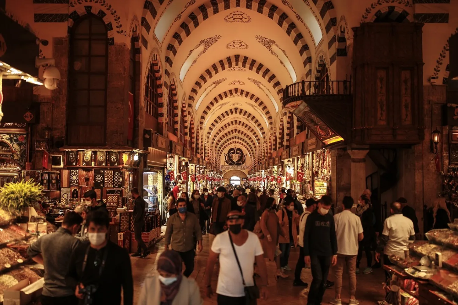 People wearing masks for protection against the spread of the coronavirus walk in the Spice Bazaar, Istanbul, Turkey, Nov. 17, 2020. (AP)