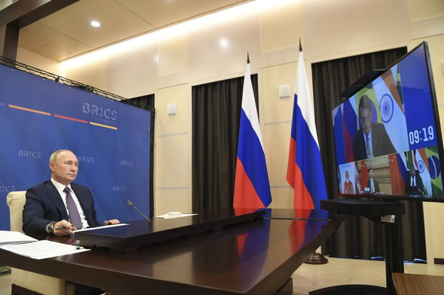 Russian President Vladimir Putin attends a meeting with BRICS leaders via video conference at the Novo-Ogaryovo residence outside Moscow, Russia, Tuesday, Nov. 17, 2020. Russian president told BRICS leaders Tuesday that coronavirus vaccines developed in Russia "work effectively and safely" and urged the group of emerging economy nations to "join forces" in their mass production. (Alexei Nikolsky, Sputnik, Kremlin Pool Photo via AP)
