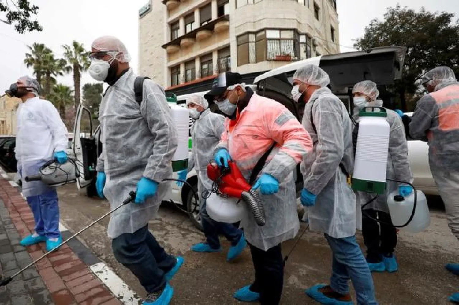 FILE PHOTO: Palestinian workers make their way to disinfect religious sites as preventive measures against the coronavirus, in Ramallah in the in the Israeli-occupied West Bank March 7, 2020. REUTERS/Mohamad Torokman/File Photo
