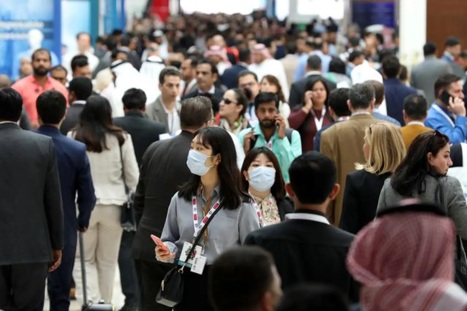 FILE PHOTO: Vistors wear masks during the Arab Health Exhibition in Dubai, United Arab Emirates January 29, 2020. REUTERS/Christopher Pike

