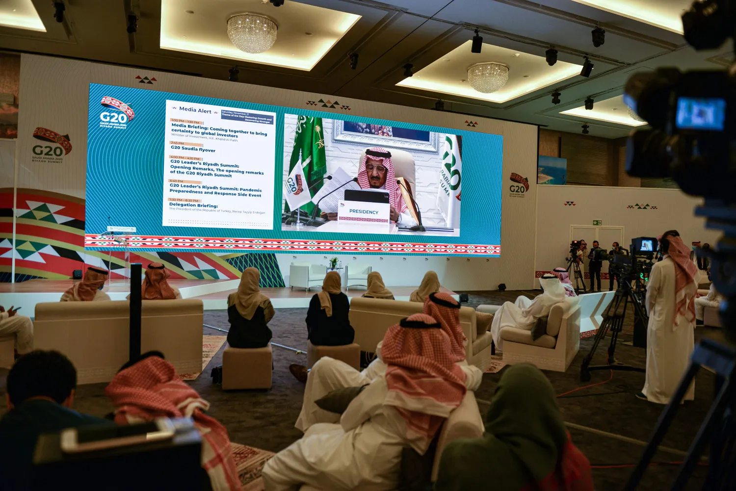 Members of the media watch on a projected screen at the International Media Center in Saudi Arabia's capital Riyadh as Saudi King Salman bin Abdulaziz gives an address opening the G20 summit on November 21. Fayez Nureldine/AFP
