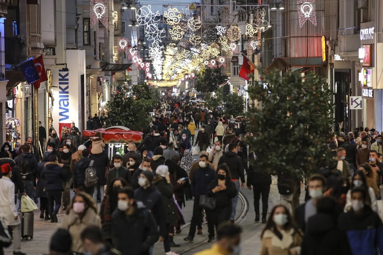 People wearing protective masks walk along Istiklal Avenue, in Istanbul, Turkey, Nov. 21, 2020. (AP)