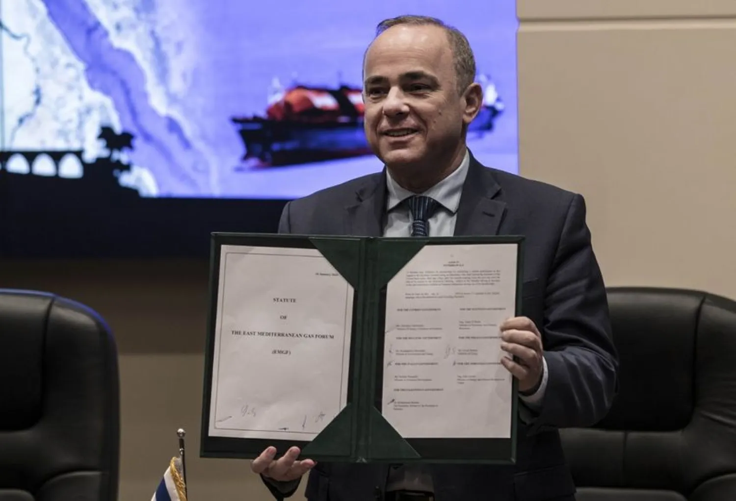 Israeli Energy Minister Yuval Steinitz displays the signed agreement during the East Mediterranean Gas Forum (EMGF), in Cairo, on January 16, 2020. (KHALED DESOUKI/AFP)