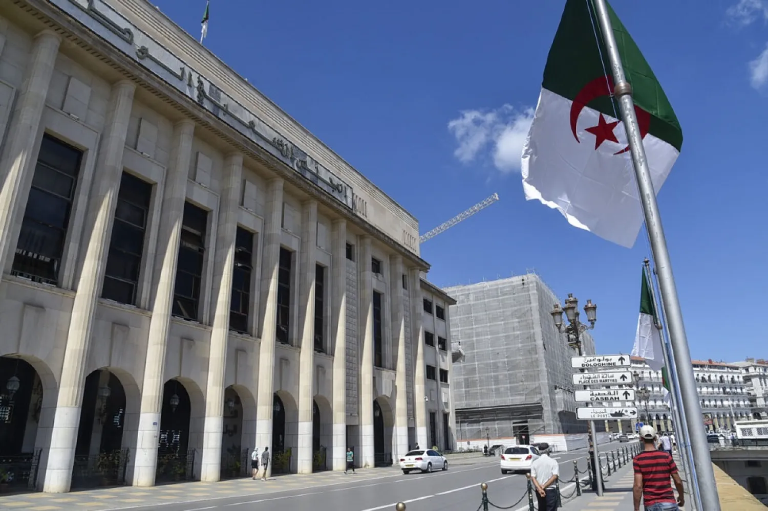 Algerians walk across from the parliament building during a voting session on constitutional reforms in the capital Algiers, on September 10, 2020. (Getty Images)