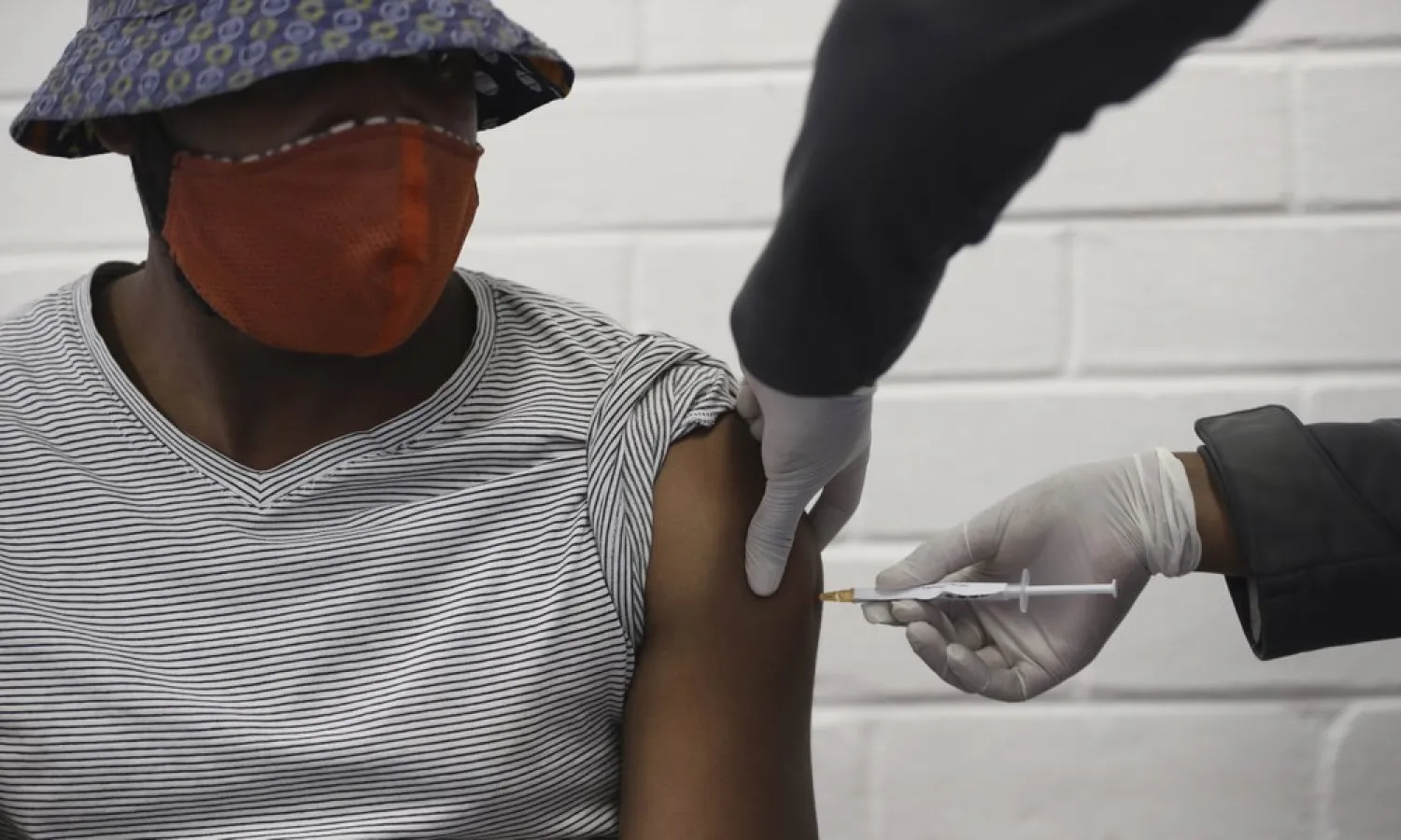 A vaccine volunteer gets an injection at the Chris Hani Baragwanath hospital in Soweto, Johannesburg Wednesday, June 24, 2020. (AP Photo/Siphiwe Sibeko)
