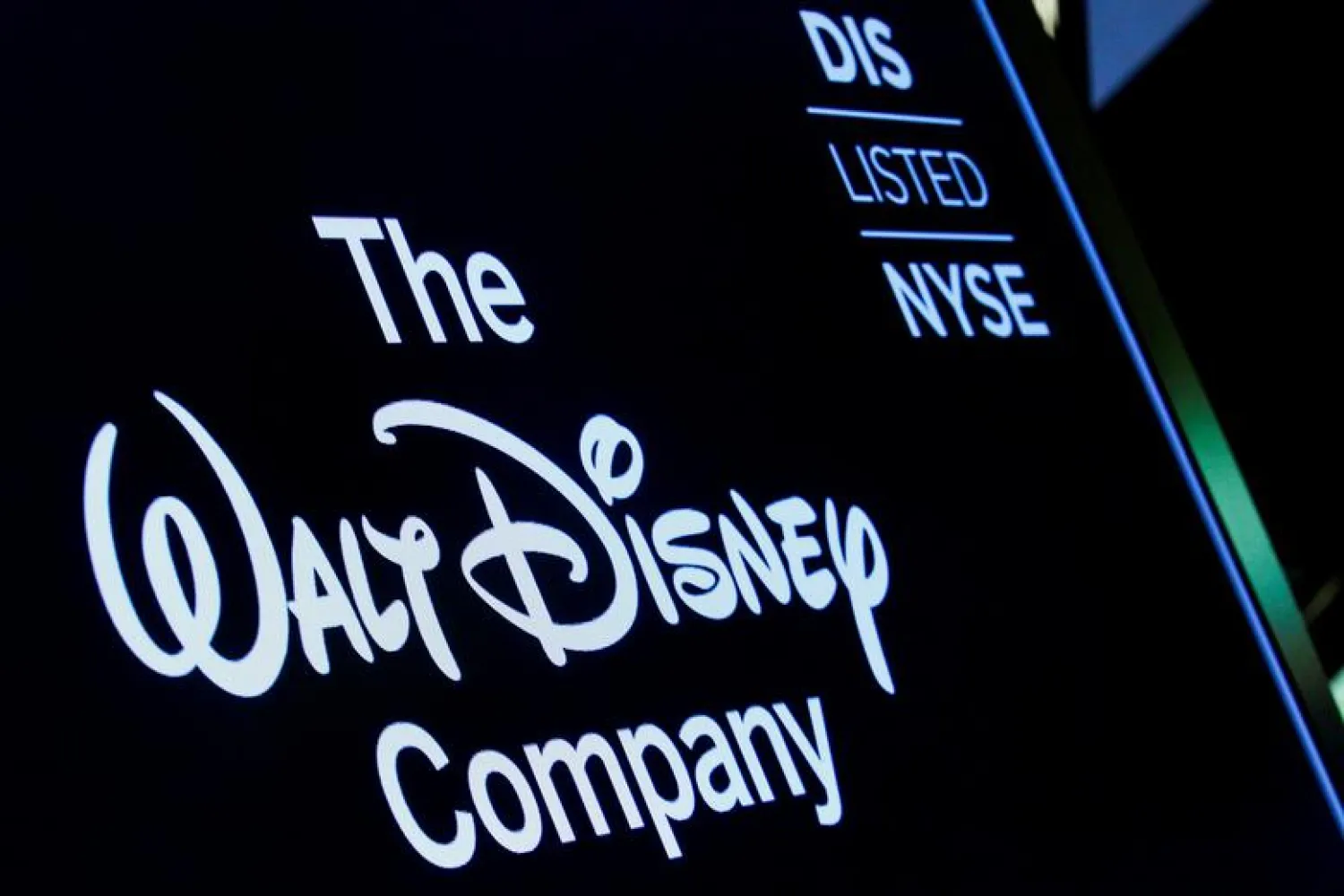 FILE PHOTO: A screen shows the logo and a ticker symbol for The Walt Disney Company on the floor of the New York Stock Exchange (NYSE) in New York, US, December 14, 2017. REUTERS/Brendan McDermid

