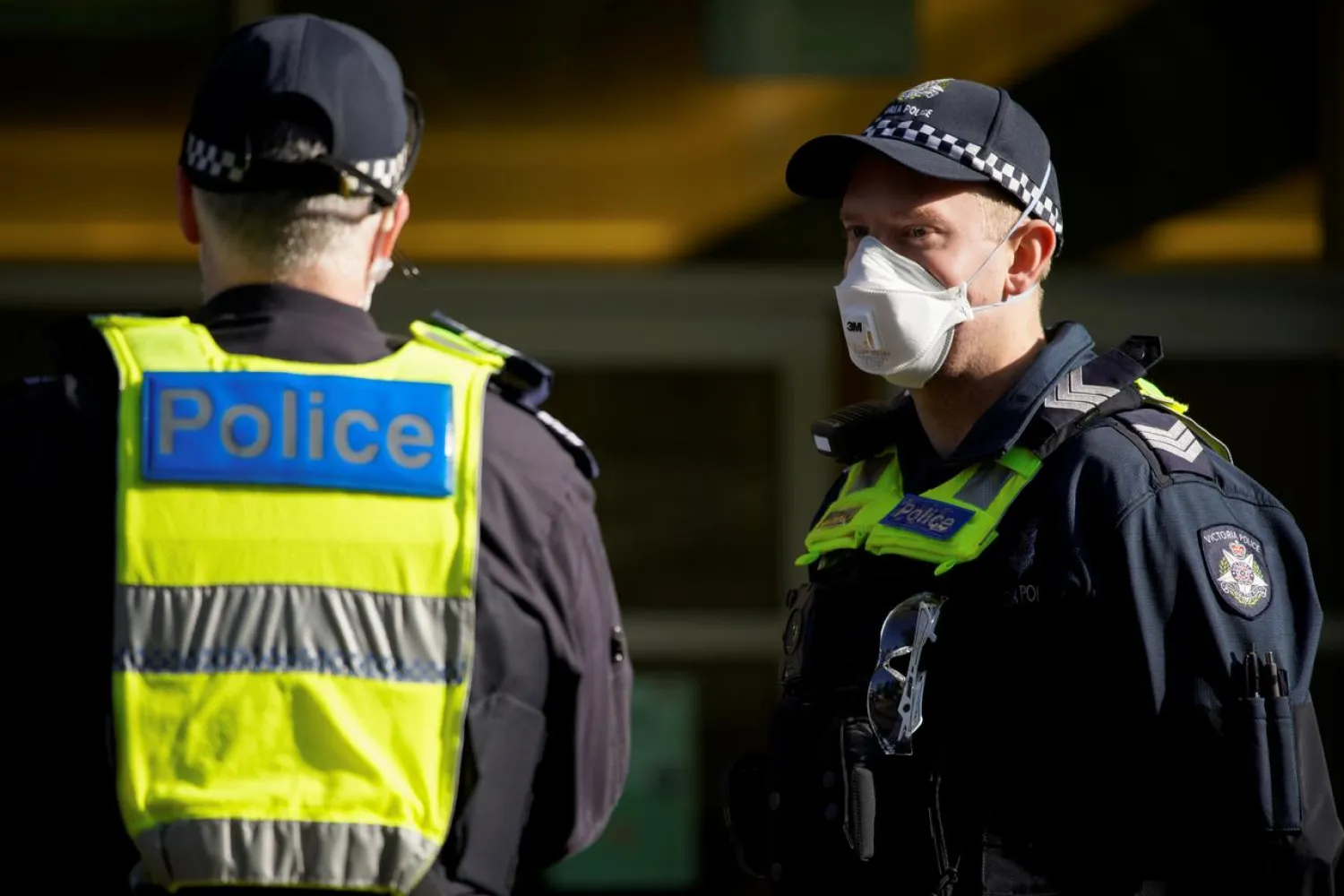 FILE PHOTO: Victoria Police officers meet outside a public housing tower, locked down in response to an outbreak of the coronavirus disease (COVID-19), in Melbourne, Australia, July 8, 2020. REUTERS/Sandra Sanders