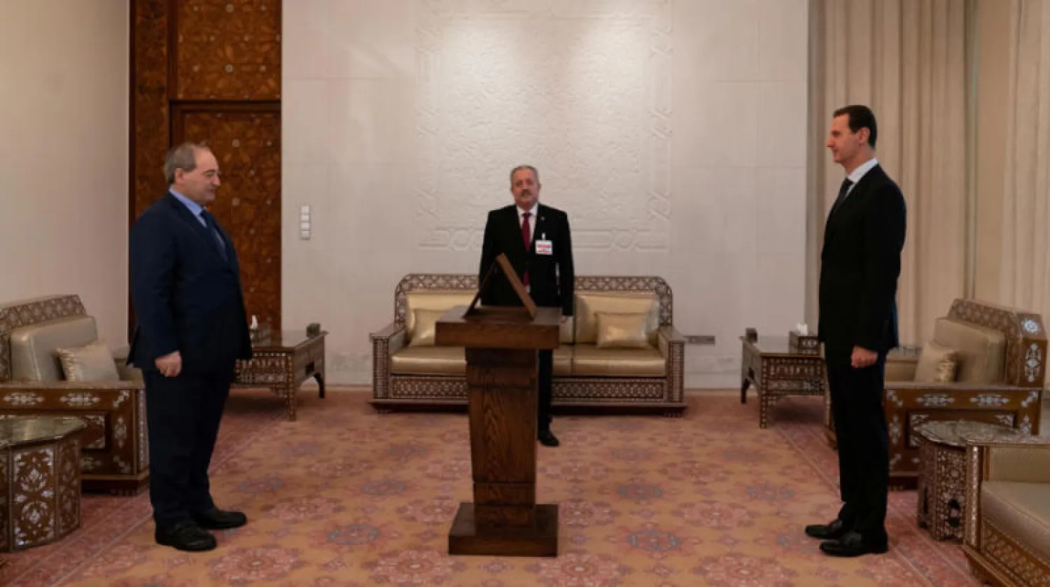 المقداد خلال أداء اليمين أمام الأسد (رويترز)