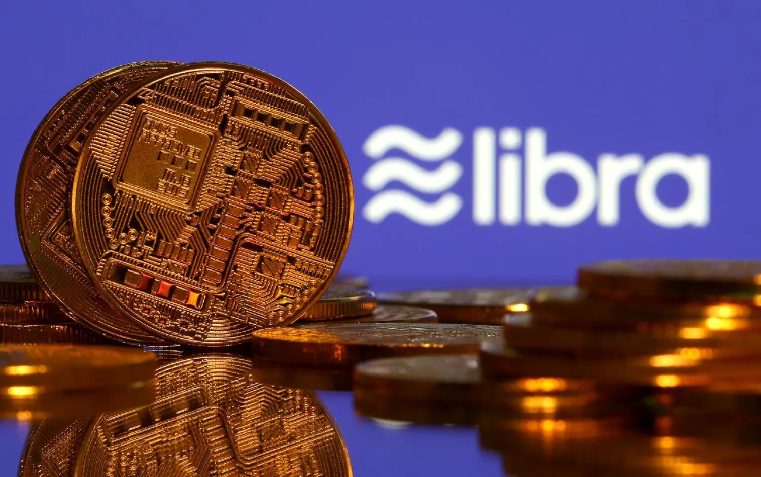 FILE PHOTO: Representations of virtual currency are displayed in front of the Libra logo in this illustration picture, June 21, 2019. REUTERS/Dado Ruvic/Illustration