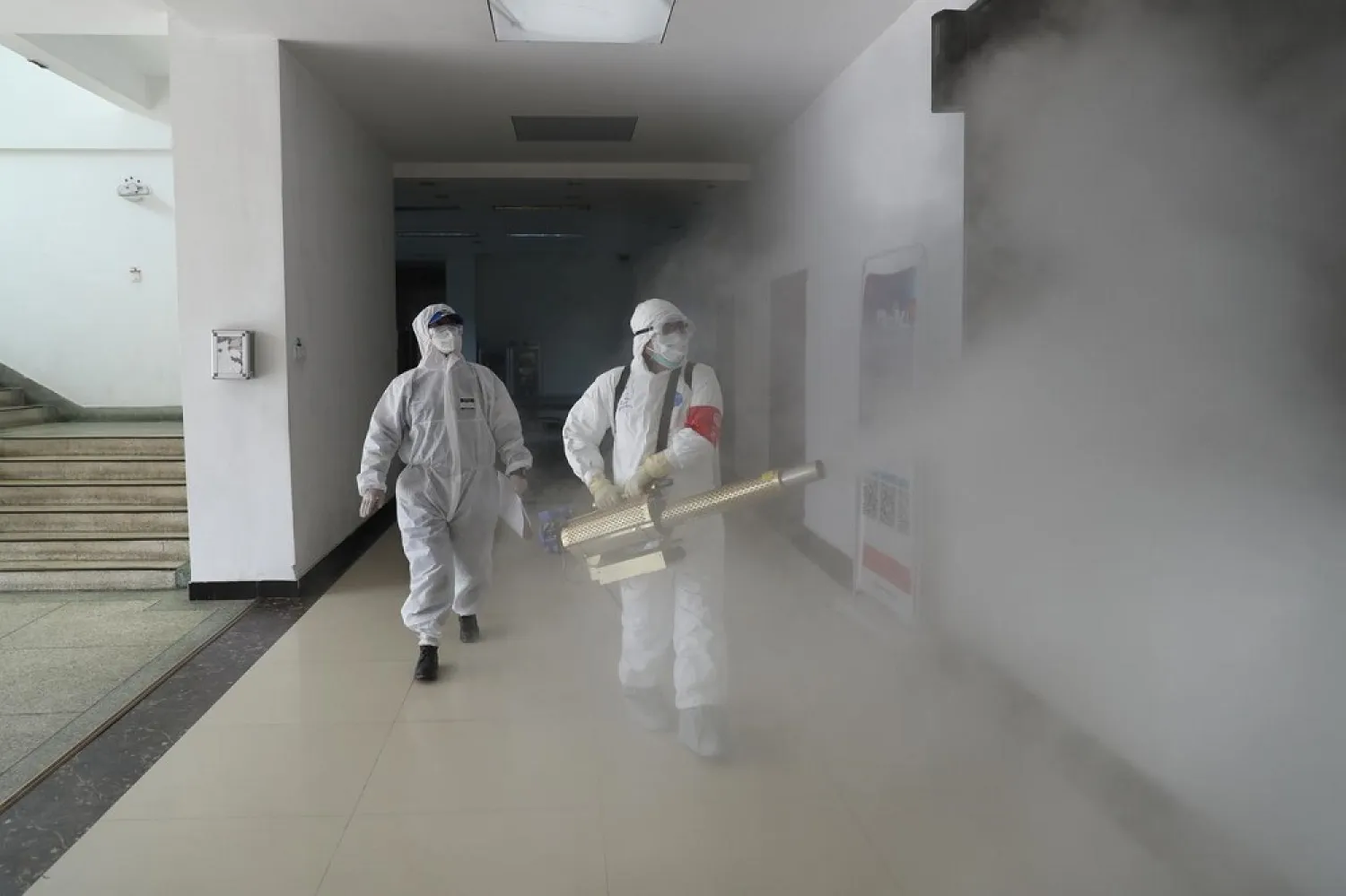 Volunteers in protective suits disinfect a residential compound in Wuhan, the epicenter of the novel coronavirus outbreak, in Hubei province, China February 22, 2020. (Reuters)