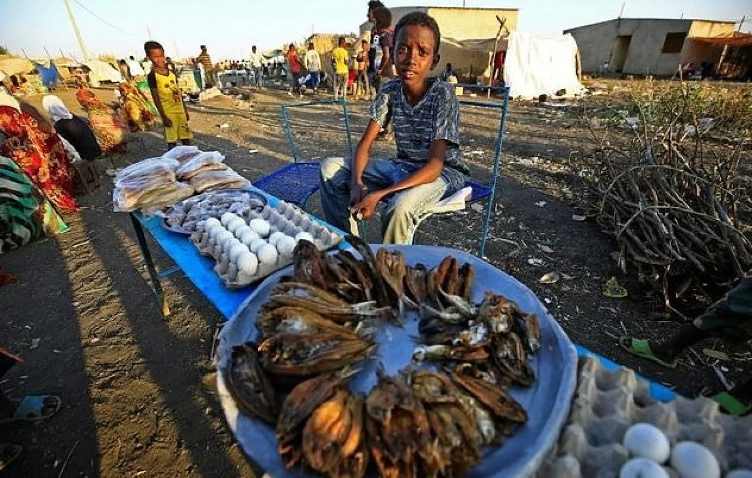 Fish, eggs and bread on sale by Ethiopian refugees to their peers. AFP