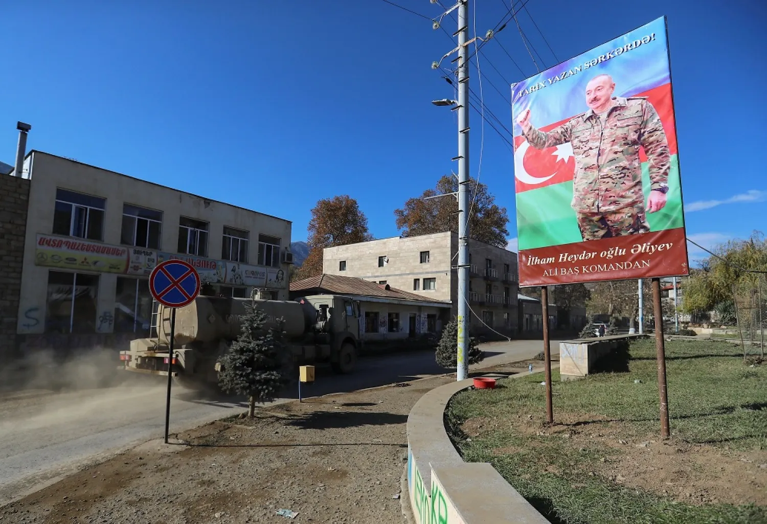 A board with an image of Azerbaijani President Ilham Aliyev seen in Hadrut town, which recently came under the control of Azerbaijan's troops, in Nagorno-Karabakh, Nov. 25, 2020. (Reuters)
