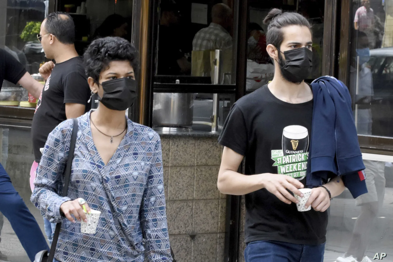 Tunisians wearing protective masks in Tunis (File photo: AP)
