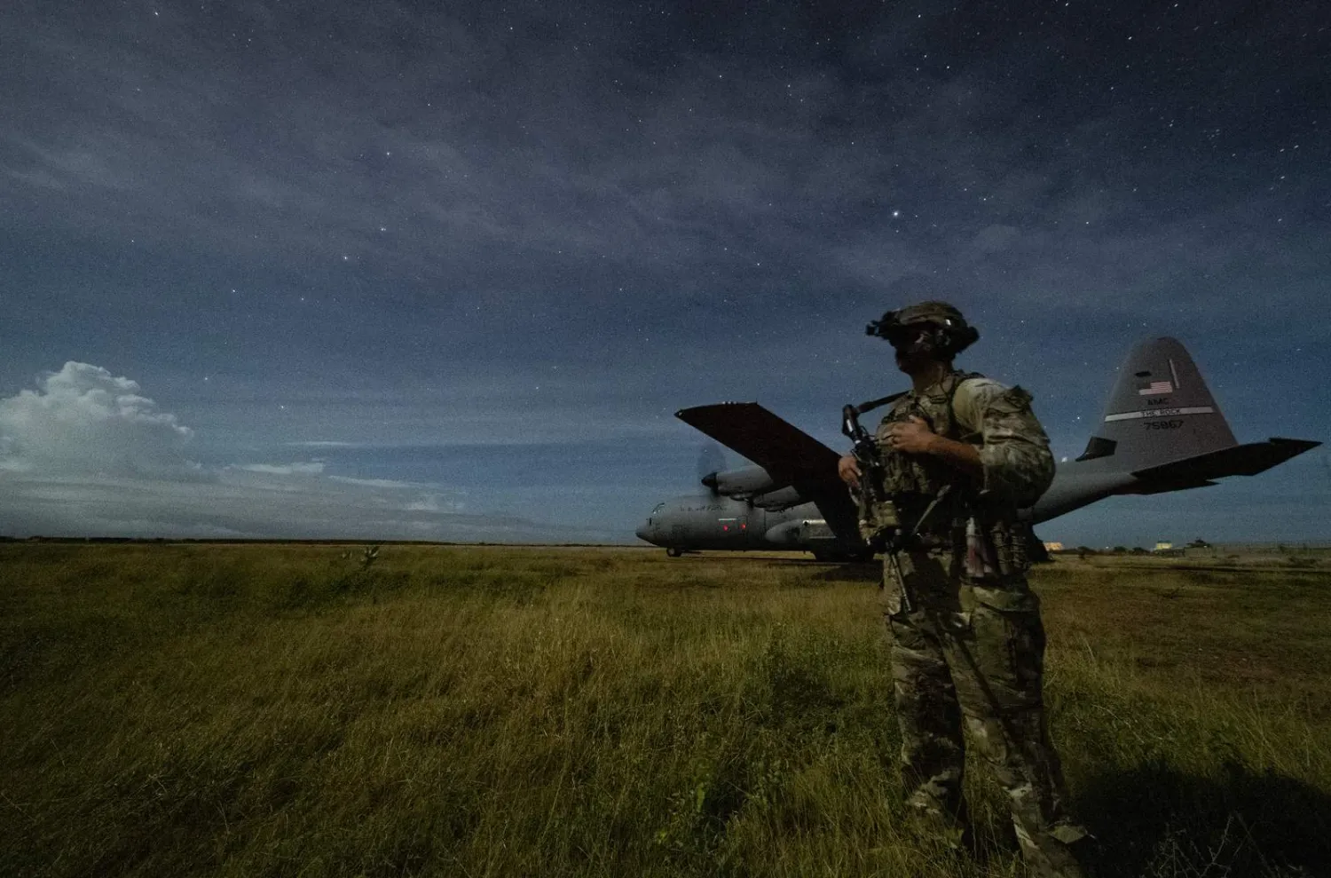 US Army Spc. Kevin Martin, junior sniper, assigned to the 1-186th Infantry Battalion, Task Force Guardian, Combined Joint Task Force - Horn of Africa, provides security for a 75th Expeditionary Airlift Squadron (EAS) C-130J Super Hercules during unloading operations at an unidentified location in Somalia Sunday, June 28, 2020. AP