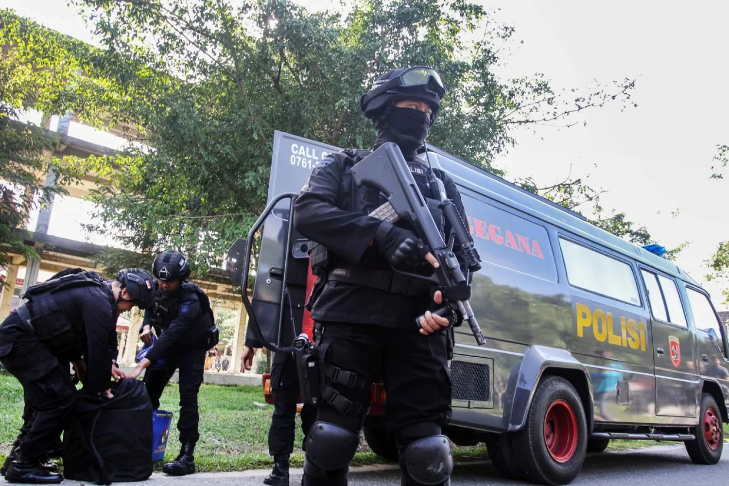 Indonesian anti-terrorism policeman holds a rifle as others seized crude bombs at Riau University building in Pekanbaru, Sumatra Island, Indonesia, June 2, 2018. Picture taken June 2, 2018. Antara Foto/Rony Muharrman/via REUTERS
