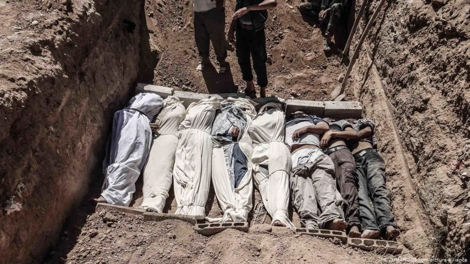 A mass grave with the bodies of those killed in a sarin gas attack on eastern Ghouta in 2013