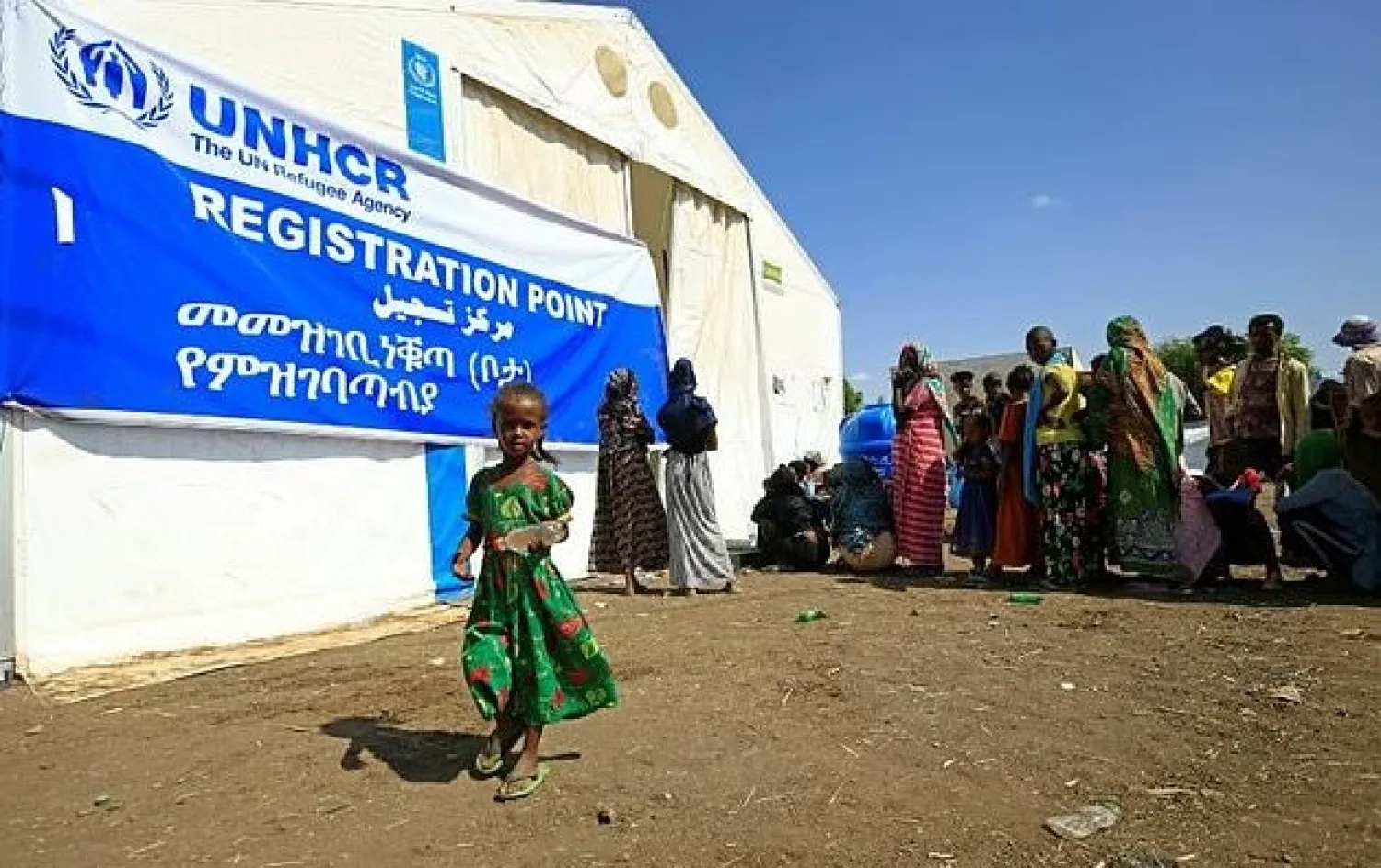 Ethiopian refugees, who have fled the Tigray conflict, queue for food outside UNHCR and World Food Programme tents at a transit centre in Sudan's border town of Hamdayit. AFP
