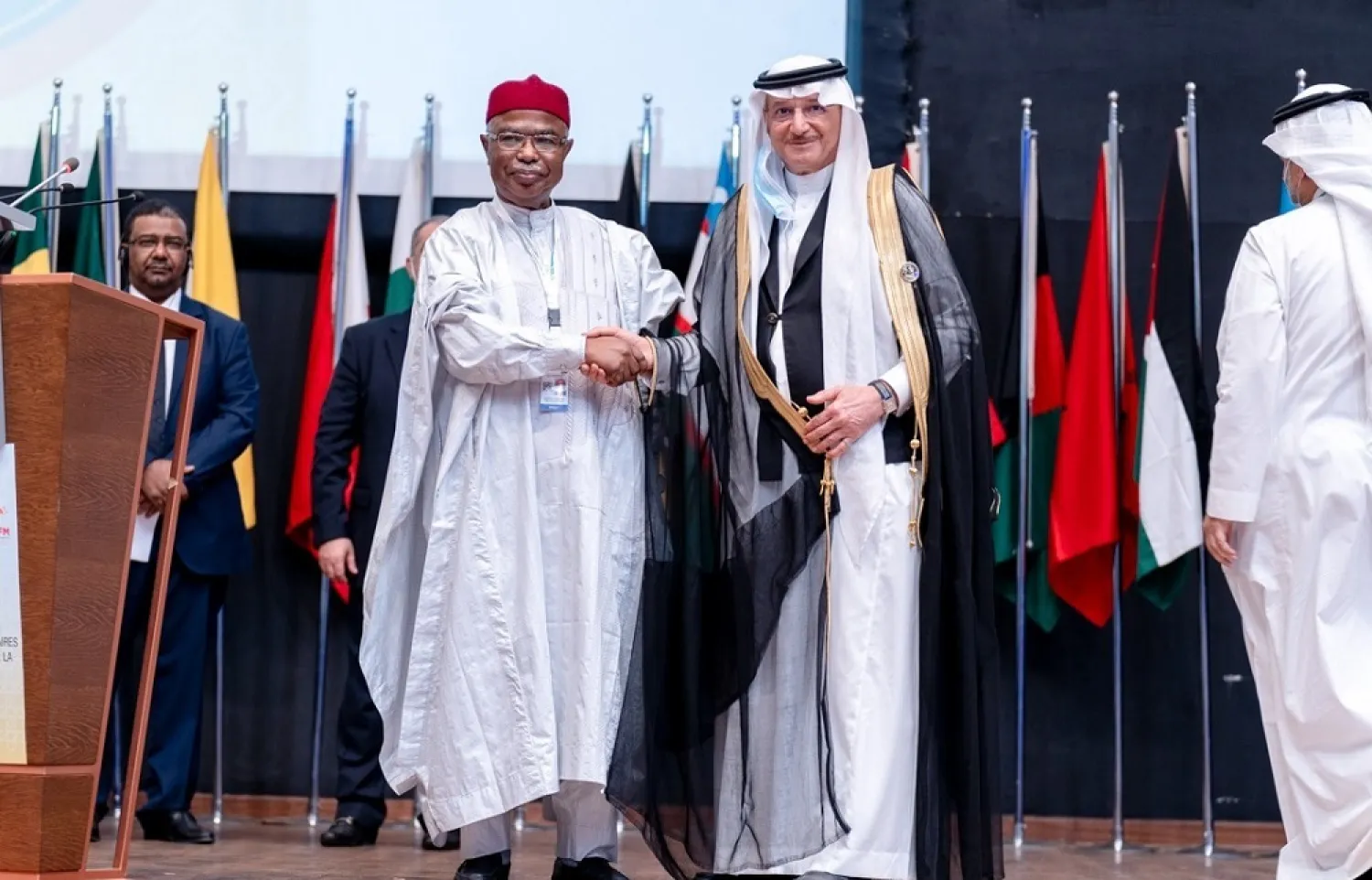 New OIC Secretary-General Hissein Brahim Taha (L) with current chief Youssef Al-Othaimeen. (OIC via Twitter)