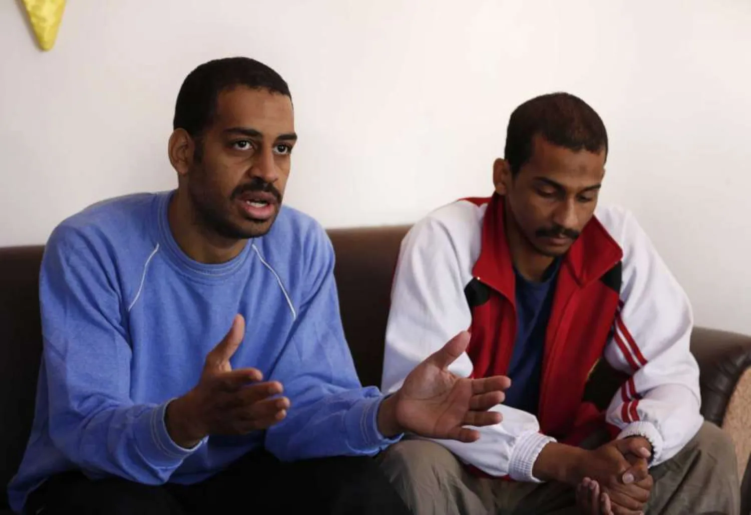 In this March 30, 2019, file photo, Alexanda Amon Kotey, left, and El Shafee Elsheikh, who were allegedly among four British militants who made up a brutal ISIS cell dubbed "The Beatles," speak during an interview with The Associated Press at a security center in Kobani, Syria. (AP Photo/Hussein Malla, File)