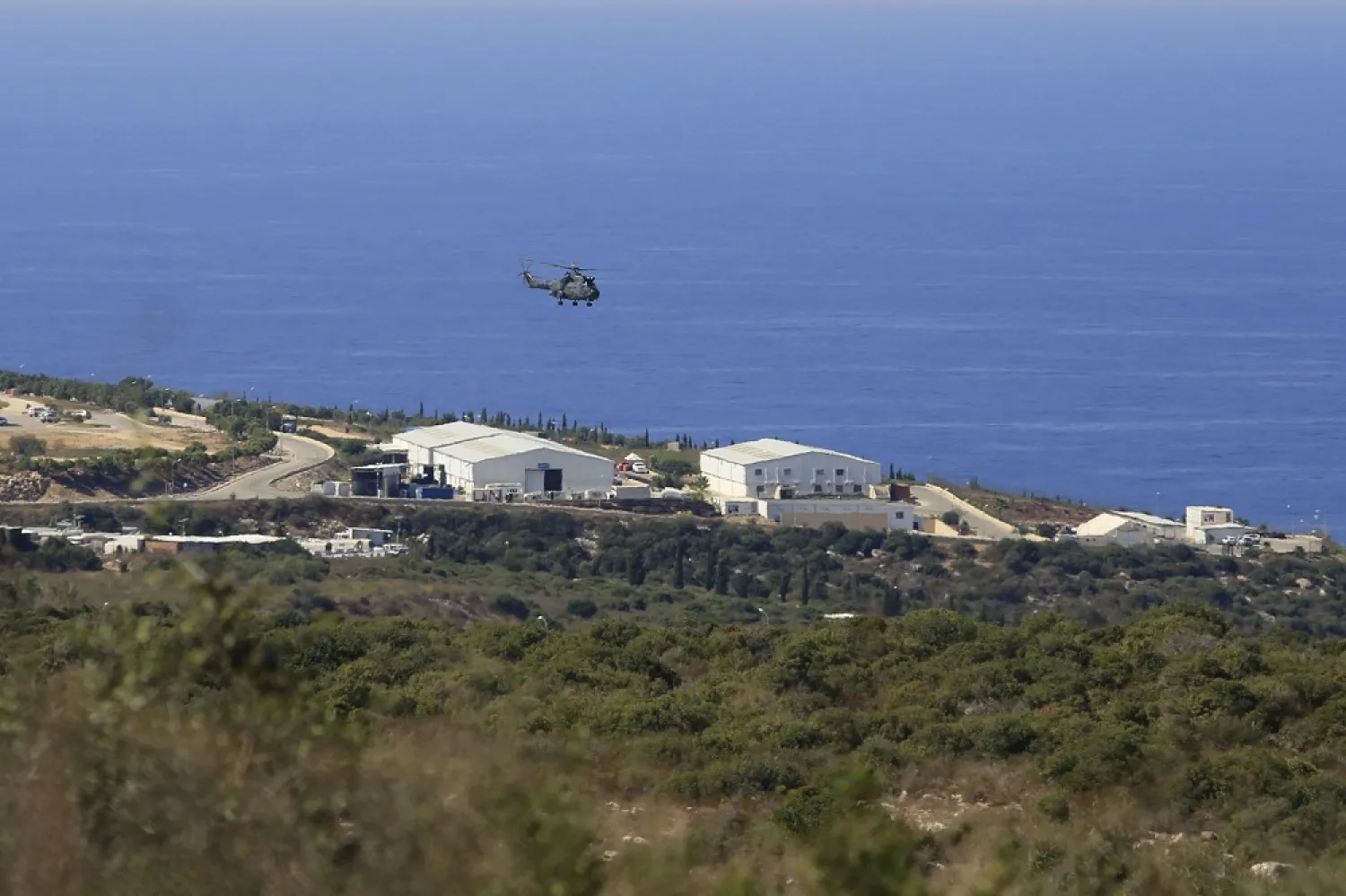 In this Oct. 14, 2020 file photo, a helicopter flies over a base of the UN peacekeeping force, in the southern town of Naqoura, Lebanon. (AP)