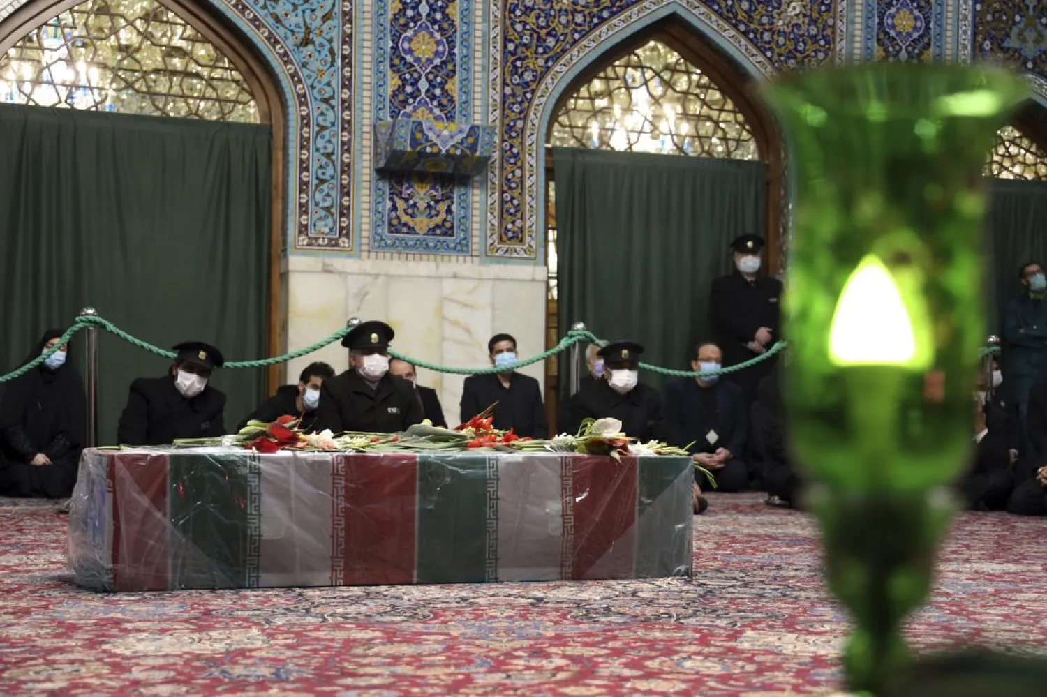 In this picture released by the Iranian Defense Ministry and taken on Saturday, Nov. 28, 2020, people pray over the coffin of Mohsen Fakhrizadeh, during a funeral in Mashhad, Iran. (AP)
