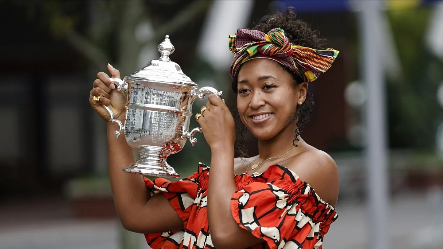 Naomi Osaka, of Japan, holds up the championship trophy while posing for photographs at the Billie Jean King National Tennis Center Sunday, Sept. 13, 2020, in New York. (AP)