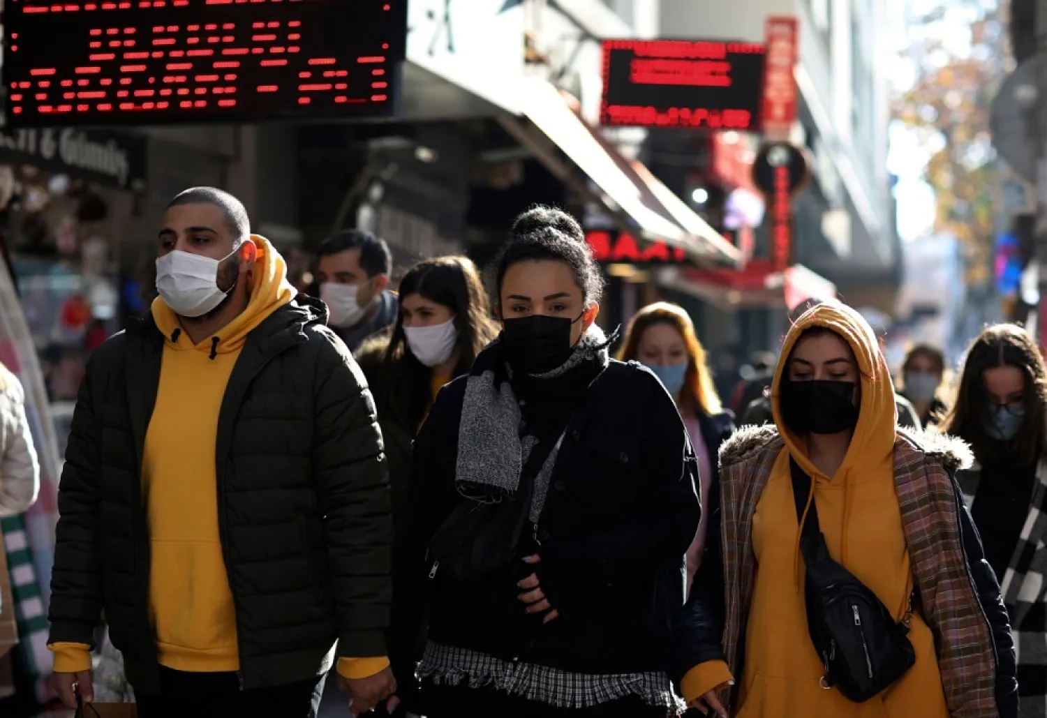 People wearing masks to help protect against the spread of coronavirus, walk in Ankara, Turkey, Friday, Nov. 27, 2020. (AP)