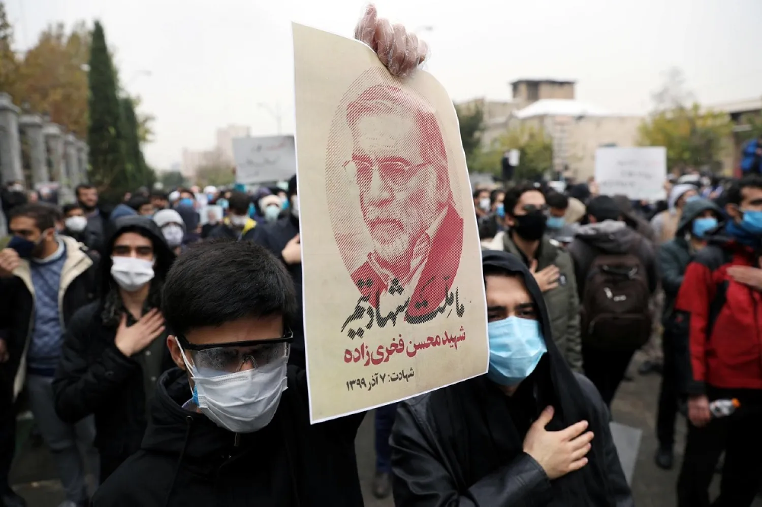 A protester holds a picture of Mohsen Fakhrizadeh, Iran's top nuclear scientist, during a demonstration on November 28, protesting against his killing in Tehran, Iran. (Reuters)